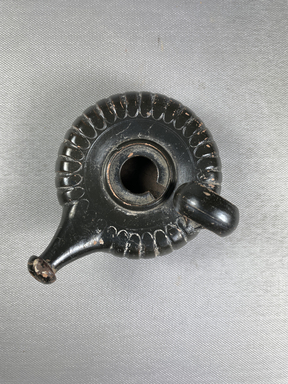 Possibly Apulian. <em>Guttus</em>, 3rd-1st century B.C.E. Clay, slip, 2 11/16 × 3 11/16 × 4 1/2 in. (6.8 × 9.4 × 11.4 cm). Brooklyn Museum, Gift of Robin F. Beningson, 1994.209.2. Creative Commons-BY (Photo: Brooklyn Museum, CUR.1994.209.2_view01.jpg)