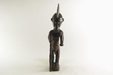 Beembe. <em>Male Figure Holding a Gun (Mukuya)</em>, 19th or 20th century. Wood, copper alloy, ceramic, 15 1/4 x 3 1/2 x 4 3/4in. (38.7 x 8.9 x 12.1cm). Brooklyn Museum, Gift of Corice and Armand P. Arman, 1995.169.2. Creative Commons-BY (Photo: Brooklyn Museum, CUR.1995.169.2_PS5.jpg)