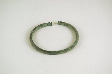 Inland Niger Delta. <em>Bracelet</em>, 200–1000 C.E.?. Copper alloy, 1/4 x 3 5/8 x 2 7/8 in.  (0.6 x 9.2 x 7.3 cm). Brooklyn Museum, Gift of Drs. John I. and Nicole Dintenfass, 1999.131.2. Creative Commons-BY (Photo: Brooklyn Museum, CUR.1999.131.2_PS5.jpg)