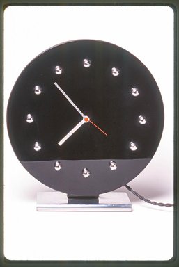 Gilbert Rohde (American, 1894-1944). <em>Clock, Model 4708</em>, ca. 1933. Glass, nickel-plated metal, 10 5/8 x 10 x 3 1/2 in. (27 x 25.4 x 8.9 cm). Brooklyn Museum, Gift of Paul F. Walter, 1999.141.1. Creative Commons-BY (Photo: Brooklyn Museum, CUR.1999.141.1.jpg)