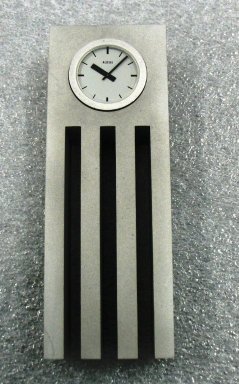 Uchida Shigeru. <em>Clock, 'Dear Vera 1', Model 06</em>, designed 1991. Anodized aluminum, quartz movement, plastic(?), 5 5/16 x 1 15/16 x 1 3/16 in. (13.5 x 4.9 x 3 cm). Brooklyn Museum, Gift of Alessi S.p.A., 1999.40.56a-c. Creative Commons-BY (Photo: Brooklyn Museum, CUR.1999.40.56a-c_view1.jpg)