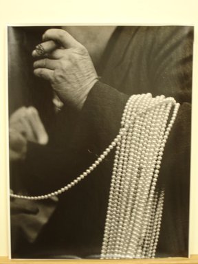 Jim Steinhardt (American, 1917-2010). <em>Man with Pearls over His Arm, Lower East Side, New York City</em>, 1947. Toned gelatin silver print, 14 x 11 in.  (35.6 x 27.9 cm). Brooklyn Museum, Gift of the artist, 1999.94.1. © artist or artist's estate (Photo: Brooklyn Museum, CUR.1999.94.1.jpg)