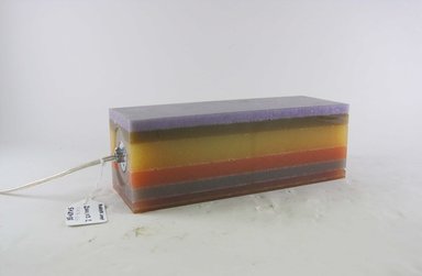 Harry Allen (American, born 1964). <em>Layered Rubber Lamp</em>, Designed and made 1997. Pigmented RTV, silicone rubber, electrical components including socket with metal bottom, light bulb, and wire, 4 x 12 x 4 in.  (10.2 x 30.5 x 10.2 cm). Brooklyn Museum, Gift of Harry Allen, 2000.103.2. Creative Commons-BY (Photo: Brooklyn Museum, CUR.2000.103.2_view1.jpg)