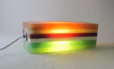 Harry Allen (American, born 1964). <em>Layered Rubber Lamp</em>, Designed and made 1997. Pigmented RTV, silicone rubber, electrical components including socket with metal bottom, light bulb, and  wire, 4 x 12 x 4 in.  (10.2 x 30.5 x 10.2 cm). Brooklyn Museum, Gift of Harry Allen, 2000.103.3. Creative Commons-BY (Photo: Brooklyn Museum, CUR.2000.103.3_view2.jpg)
