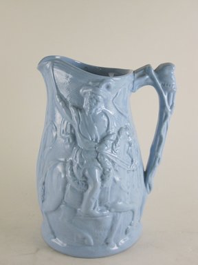 Attributed to Henry Baggeley (English, 19th century). <em>Jug, Garibaldi Pattern</em>, After 1864. Blue glazed stoneware, 7 7/8 x 5 7/8 x 4 3/4 in.  (20.0 x 14.9 x 12.1 cm). Brooklyn Museum, Gift of Gretchen Adkins, 2000.126.1. Creative Commons-BY (Photo: Brooklyn Museum, CUR.2000.126.1_view1.jpg)