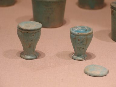  <em>Vessel and Cover for (M)edjat-oil</em>, 360-30 B.C.E. Faience, 1 3/8 x 1 3/16 in. (3.5 x 3 cm). Brooklyn Museum, Gift of Wunsch Foundation, Inc., 2002.18.2a-b. Creative Commons-BY (Photo: , CUR.2002.18.1a-b_2002.18.2a-b_wwg8.jpg)