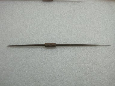 Possibly Chimú. <em>Spindle with Whorl</em>, 1100-1450. Wood, pigment, 11 3/4 x 1/2 x 1/2 in. (29.8 x 1.3 x 1.3 cm). Brooklyn Museum, Gift of Victor P. Nunez, 2004.53.44. Creative Commons-BY (Photo: , CUR.2004.53.44_view01.jpg)