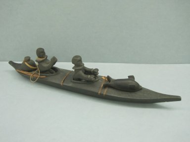 Inuit. <em>Kayak with Buoy, Two Figures, and a Seal</em>, 1950-1980. Stone, wood, rawhide bands, bone remnants, a (kayak): 1 1/2 x 2 x 14 in. (3.8 x 5.1 x 35.6 cm). Brooklyn Museum, Hilda and Al Schein Collection, 2004.79.17a-g. Creative Commons-BY (Photo: Brooklyn Museum, CUR.2004.79.17a-g.jpg)