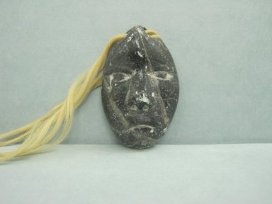 Inuit. <em>Amulet in the Form of a Head</em>, 1950–1980. Soapstone, 1 5/8 x 1 1/8 x 3/8 in. (4.1 x 2.9 x 1 cm). Brooklyn Museum, Hilda and Al Schein Collection, 2004.79.31. Creative Commons-BY (Photo: Brooklyn Museum, CUR.2004.79.31.jpg)