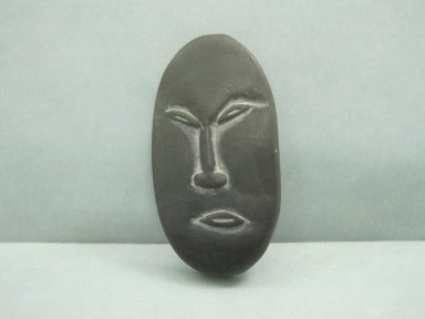 Inuit. <em>Amulet in the Form of a Head</em>, 1950–1980. Soapstone, 2 3/8 x 1 1/8 x 1/4 in. (6 x 2.9 x 0.6 cm). Brooklyn Museum, Hilda and Al Schein Collection, 2004.79.66. Creative Commons-BY (Photo: Brooklyn Museum, CUR.2004.79.66.jpg)