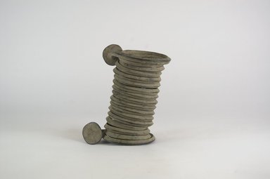 Igbo. <em>Coiled Armlet</em>, 19th century. Copper alloy, 3 3/8 x 5 7/8 in. (8.5 x 15 cm). Brooklyn Museum, Gift of Dr. Werner Muensterberger and Michael Ward, 2006.66.3. Creative Commons-BY (Photo: Brooklyn Museum, CUR.2006.66.3_view1_PS5.jpg)