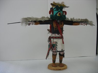 probably Henry Shelton (born 1929). <em>Kachina Doll</em>, 1960-1970. Cottonwood root, acrylic pigment, feathers, yarn, leather, 19 1/2 x 27 x 5 in. (49.5 x 68.6 x 12.7 cm). Brooklyn Museum, Gift of Edith and Hershel Samuels, 2010.6.13. Creative Commons-BY (Photo: Brooklyn Museum, CUR.2010.6.13.jpg)