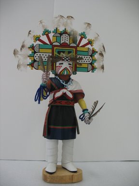 Henry Shelton (1929–2016). <em>Kachina Doll (Paalhikmana)</em>, 1960–1970. Cottonwood root, acrylic pigment, feathers, yarn, beads, 19 x 10 x 5 1/2 in. (48.3 x 25.4 x 14 cm). Brooklyn Museum, Gift of Edith and Hershel Samuels, 2010.6.6. Creative Commons-BY (Photo: Brooklyn Museum, CUR.2010.6.6.jpg)