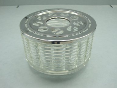 Peter Mueller-Munk (American, 1904–1967). <em>Candle Warmer</em>, Patented September 27, 1949. Glass and chromed metal, 3 5/8 x 6 in. (9.2 x 15.2 cm). Brooklyn Museum, Gift of David A. Hanks in honor of Jewel Stern, 2010.75.1a-c. Creative Commons-BY (Photo: Brooklyn Museum, CUR.2010.75.1a-c.jpg)