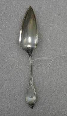  <em>Cheese Slice</em>, Patented 1874. Silver, 7 9/16 x 1 3/8 x 1 1/8 in. (19.2 x 3.5 x 2.9 cm). Brooklyn Museum, Gift of William Lee Younger in memory of Joseph A. Henehan, 2010.77.16. Creative Commons-BY (Photo: Brooklyn Museum, CUR.2010.77.16_back.jpg)