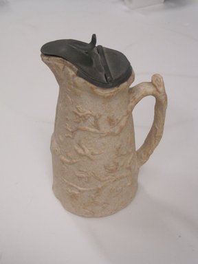 Bennington Potteries, Fenton Works. <em>Syrup Pitcher, Bird and Nest</em>, 1847-1857. Glazed and unglazed ceramic, pewter, 7 1/8 x 3 7/16 x 4 1/4 in. (18.1 x 8.7 x 10.8 cm). Brooklyn Museum, Gift of Sarah B. Sherrill, 2013.46.2. Creative Commons-BY (Photo: Brooklyn Museum, CUR.2013.46.2.jpg)