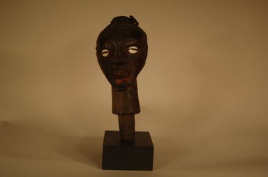 Songye. <em>Head</em>, 20th century. Wood, cowrie shell, fiber, organic materials, 7 1/2 x 2 3/4 x 3 3/8 in. (19 x 7 x 8.5 cm). Brooklyn Museum, Gift in memory of Frederic Zeller, 2014.54.45 (Photo: Brooklyn Museum, CUR.2014.54.45_overall.jpg)