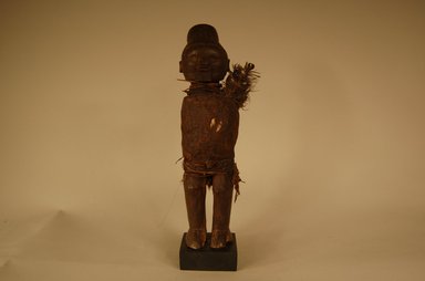 Teke. <em>Figure of Male</em>, early 20th century. Wood, feathers, fiber, cowrie shell, hide, glass, resin, 10 1/4 x 3 1/8 x 3 1/4 in. (26 x 8 x 8.3 cm). Brooklyn Museum, Gift in memory of Frederic Zeller, 2014.54.50 (Photo: Brooklyn Museum, CUR.2014.54.50_overall.jpg)