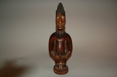 Yorùbá artist. <em>Male twin figure (Ère Ìbejì)</em>, 20th century. Wood, pigment, beads, 11 7/16 x 3 15/16 x 2 3/8 in. (29 x 10 x 6 cm). Brooklyn Museum, Gift in memory of Frederic Zeller, 2014.54.53 (Photo: Brooklyn Museum, CUR.2014.54.53_overall1.jpg)