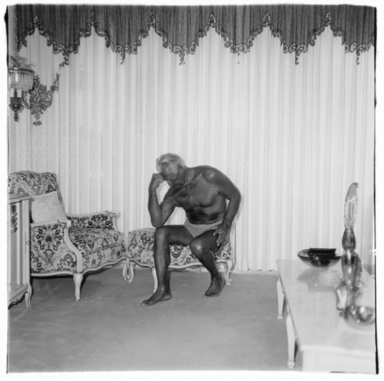 Diane Arbus (American, 1923–1971). <em>Charles Atlas Seated in His Palm Beach Home, Fla.</em>, 1969. Gelatin silver print, sheet: 20 × 16 in. (50.8 × 40.6 cm). Brooklyn Museum, Gift of Jeffrey Fraenkel and Frish Brandt, 2019.49.3 (Photo: Image courtesy of Fraenkel Gallery, CUR.2019.49.3_FraenkelGallery_photograph.jpg)