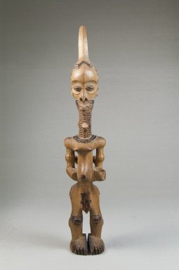 Lulua. <em>Woman with Child on Back (Lupingu Lua Luimpe)</em>, early 20th century. Wood, 11 1/2 x 2 1/2 x 3 in. (29.2 x 6.4 x 7.6 cm). Brooklyn Museum, Museum Expedition 1922, Robert B. Woodward Memorial Fund, 22.107. Creative Commons-BY (Photo: Brooklyn Museum, CUR.22.107_front_PS5.jpg)