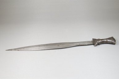 Boa. <em>Knife</em>, 19th century. Iron, copper alloy, 1 3/8 x 16 3/4 in. (3.5 x 42.5 cm). Brooklyn Museum, Museum Expedition 1922, Robert B. Woodward Memorial Fund, 22.1080. Creative Commons-BY (Photo: Brooklyn Museum, CUR.22.1080_side_PS5.jpg)
