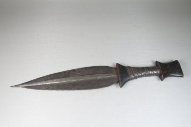 Buaka. <em>Knife</em>, 19th century. Iron, wood, 2 3/8 x 14 9/16 in. (6 x 37 cm). Brooklyn Museum, Museum Expedition 1922, Robert B. Woodward Memorial Fund, 22.1083. Creative Commons-BY (Photo: Brooklyn Museum, CUR.22.1083_side_PS5.jpg)