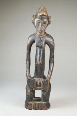 Senufo. <em>Figure of a Seated Male</em>, late 19th or early 20th century. Wood, glass beads, 10 3/4 x 3 x 2 3/4 in. (27.3 x 7.6 x 7 cm). Brooklyn Museum, Museum Expedition 1922, Robert B. Woodward Memorial Fund, 22.1093. Creative Commons-BY (Photo: Brooklyn Museum, CUR.22.1093_front_PS5.jpg)