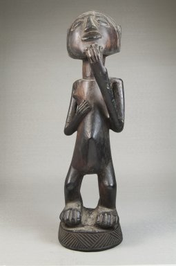 Possibly Luba. <em>Figure of a Standing Female</em>, late 19th or early 20th century. Wood, 11 x 3 1/4 x 4 in. (27.9 x 8.3 x 10.2 cm). Brooklyn Museum, Museum Expedition 1922, Robert B. Woodward Memorial Fund, 22.1129. Creative Commons-BY (Photo: Brooklyn Museum, CUR.22.1129_front_PS5.jpg)