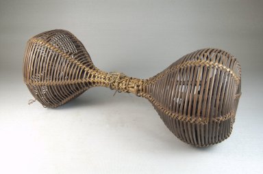Chokwe. <em>Double Basket Rattle (Musambo)</em>, late 19th or early 20th century. Rattan, seeds, 12 1/4 x 5 1/8 in. (31.2 x 13.0 cm). Brooklyn Museum, Museum Expedition 1922, Robert B. Woodward Memorial Fund, 22.1277. Creative Commons-BY (Photo: Brooklyn Museum, CUR.22.1277_threequarter_PS5.jpg)