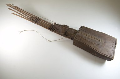 Mangbetu. <em>Five Stringed Harp with Boar's Head Decoration (Kundi)</em>, late 19th or early 20th century. Wood, fiber, 4 1/2 x 35 1/2 x 6 3/4 in. (11.4 x 90.2 x 17.1 cm). Brooklyn Museum, Museum Expedition 1922, Robert B. Woodward Memorial Fund, 22.1301. Creative Commons-BY (Photo: Brooklyn Museum, CUR.22.1301_threequarter_PS5.jpg)