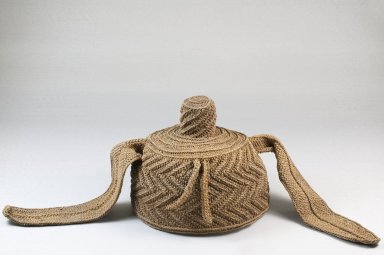 Possibly Kuba (Nkutshu subgroup). <em>Cap With Topknot and Side Extensions</em>, late 19th or early 20th century. Raffia thread, 5 15/16 x 8 7/8 x 8 7/8 in. (15.1 x 22.5 x 22.5 cm). Brooklyn Museum, Museum Expedition 1922, Robert B. Woodward Memorial Fund, 22.1641. Creative Commons-BY (Photo: Brooklyn Museum, CUR.22.1641_front_PS5.jpg)