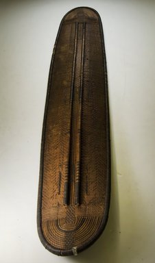 Kundu. <em>Shield</em>, 19th century. Wood, fiber, 55 1/8 x 9 13/16 in. (140 x 25 cm). Brooklyn Museum, Museum Expedition 1922, Robert B. Woodward Memorial Fund, 22.1689. Creative Commons-BY (Photo: Brooklyn Museum, CUR.22.1689_front_PS5.jpg)