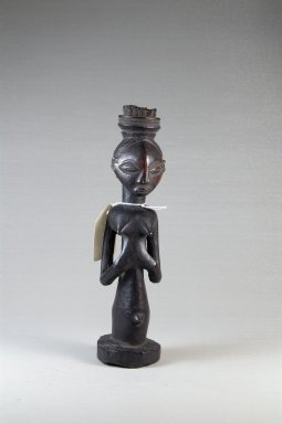 Luba. <em>Female Figure with Medicinal Charge</em>, late 19th or early 20th century. Wood, cloth, cordage, metal, 9 1/2 x 3 x 2 3/4 in. (24.1 x 7.6 x 7 cm). Brooklyn Museum, Museum Expedition 1922, Robert B. Woodward Memorial Fund, 22.168. Creative Commons-BY (Photo: Brooklyn Museum, CUR.22.168_front_PS5.jpg)