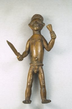 Bwayen (We, flourished 1920s-1930s). <em>Male Nude Holding Knife and Horn</em>, early 20th century. Copper alloy, 7 1/4 x 3 3/4 x 3in. (18.4 x 9.5 x 7.6cm). Brooklyn Museum, Museum Expedition 1922, Robert B. Woodward Memorial Fund, 22.212. Creative Commons-BY (Photo: Brooklyn Museum, CUR.22.212_front_PS5.jpg)