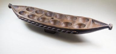 Possibly Bullom. <em>Mancala Game Board</em>, late 19th century. Wood, 25 3/4 x 5 1/2 x 6 1/2 in.  (65.4 x 14 x 16.5 cm). Brooklyn Museum, Museum Expedition 1922, Robert B. Woodward Memorial Fund, 22.213. Creative Commons-BY (Photo: Brooklyn Museum, CUR.22.213_threequarter_PS5.jpg)