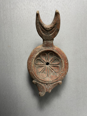 Roman. <em>Fictile Lamp</em>, 1st century. Clay, 2 3/16 × 3 1/8 × 6 in. (5.5 × 8 × 15.2 cm). Brooklyn Museum, Gift of Mrs. Frederic H. Betts, 22.32. Creative Commons-BY (Photo: Brooklyn Museum, CUR.22.32_view01.jpeg)