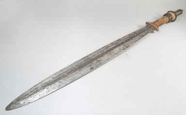 Yaka. <em>Sword</em>, 19th century. Iron, leather, 1 15/16 x 27 3/4 in. (5 x 70.5 cm). Brooklyn Museum, Museum Expedition 1922, Robert B. Woodward Memorial Fund, 22.390. Creative Commons-BY (Photo: Brooklyn Museum, CUR.22.390_threequarter_PS5.jpg)