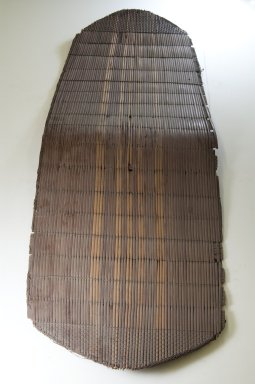 Soko. <em>Shield and Handle</em>, late 19th century. Fiber and hardwood, Shield (a): 48 7/16 x 16 1/8 in. (123.0 x 41.0 cm). Brooklyn Museum, Museum Expedition 1922, Robert B. Woodward Memorial Fund, 22.855a-b. Creative Commons-BY (Photo: Brooklyn Museum, CUR.22.855a_front_PS5.jpg)