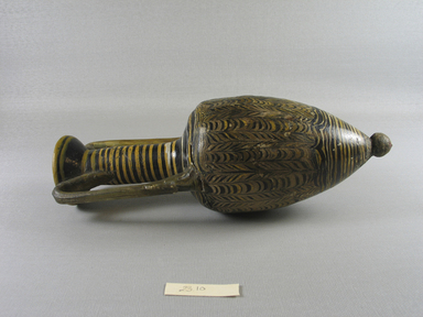 Roman. <em>Amphora</em>, 1st century B.C.E.-4th century C.E. Glass, 9 5/8 x width at top 3 3/8 x diam. 3 5/16 in. (24.5 x 8.6 x 8.4 cm). Brooklyn Museum, Brooklyn Museum Collection, 23.10. Creative Commons-BY (Photo: Brooklyn Museum, CUR.23.10DUP1_view1.jpg)