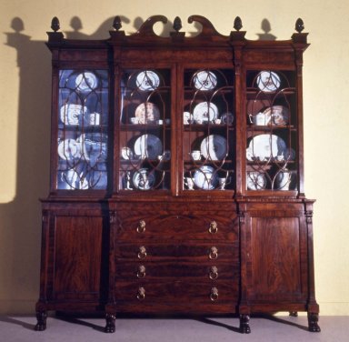 Attributed to Charles Christian (American, active 1810–1815). <em>Bookcase on Cabinet Base With Pediment Top</em>, ca. 1813. Mahogany, 67 1/2 x 23 x 97 11/16 in. (171.5 x 58.4 x 248.2 cm). Brooklyn Museum, Gift of Adrian and Henry B. Van Sinderen, 24.373. Creative Commons-BY (Photo: Brooklyn Museum, CUR.24.373_front.jpg)