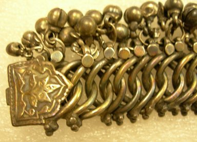  <em>Anklet, One of a Pair</em>. silver links with tiny bells, L. overall 10 in; W. silver links 3/4 in; W. including bells 1 3/8 in. Brooklyn Museum, 25608. Creative Commons-BY (Photo: Brooklyn Museum, CUR.25608_detail2.jpg)