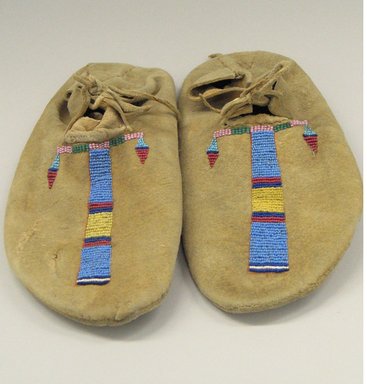 Cheyenne. <em>Pair of Moccasins, Part of War Outfit</em>, late 19th–early 20th century. Hide, beads, pigment, 10 13/16 x 4 3/4 in. (27.5 x 12.1 cm). Brooklyn Museum, Robert B. Woodward Memorial Fund, 26.794a-b. Creative Commons-BY (Photo: Brooklyn Museum, CUR.26.794a-b.jpg)