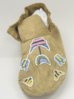 Blackfoot. <em>Moccasin with Beaded Floral Decoration</em>, late 19th century. Hide, cloth, beads, 11 x 4 1/8in. (28 x 10.5cm). Brooklyn Museum, Robert B. Woodward Memorial Fund, 26.796. Creative Commons-BY (Photo: Brooklyn Museum, CUR.26.796_view1.jpg)