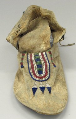 Blackfoot. <em>Moccasin with Red, White Blue and Green Beading</em>, 1880-1890. Hide, beads, 3 3/4 x 4 5/16 x 10 13/16in. (9.5 x 11 x 27.5cm). Brooklyn Museum, Robert B. Woodward Memorial Fund, 26.797. Creative Commons-BY (Photo: Brooklyn Museum, CUR.26.797_view1.jpg)