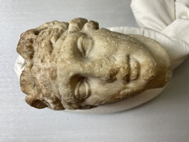 Roman. <em>Head of Aphrodite</em>. Marble, 5 9/16 × 3 15/16 × 4 1/8 in. (14.2 × 10 × 10.5 cm). Brooklyn Museum, Gift of Bianca Olcott in memory of her father, Professor George M. Olcott of Columbia University, of her grandfather, George N. Olcott, and of her great-grandfather, Charles M. Olcott, President of the Brooklyn Institute of Arts and Sciences 1851-1853, 29.1604. Creative Commons-BY (Photo: Brooklyn Museum, CUR.29.1604_view01.jpg)