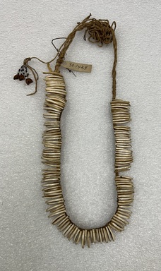 Makushi-Monaiko. <em>Necklace</em>. Agouti teeth strung on cotton with a tassel of beads and nut shells., 5 1/4 × 1/2 × 13 1/2 in. (13.3 × 1.3 × 34.3 cm). Brooklyn Museum, Museum Expedition 1930, Robert B. Woodward Memorial Fund and the Museum Collection Fund, 30.1429. Creative Commons-BY (Photo: Brooklyn Museum photogaph, CUR.30.1429.jpg)