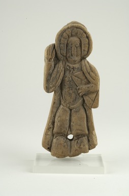 Coptic. <em>Figure of a Saint Holding Book in Left Hand</em>, 10th–11th century C.E. Wood, 3 3/8 x 3/4 x 8 9/16 in. (8.6 x 1.9 x 21.8 cm). Brooklyn Museum, Gift of Ruth Tishner Costantino, 30.27. Creative Commons-BY (Photo: Brooklyn Museum (in collaboration with Index of Christian Art, Princeton University), CUR.30.27_view1_ICA.jpg)