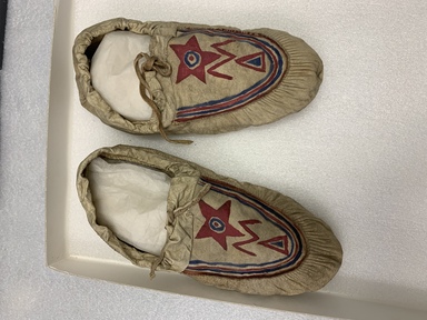 Naskapi. <em>Pair of Moccasins</em>, early 20th century. Skin, paint, 4 1/2 x 8 1/4 in. (11.5 x 21 cm). Brooklyn Museum, Museum Expedtion 1931, Museum Collection Fund, 31.1982. Creative Commons-BY (Photo: , CUR.31.1982_overall.jpg)