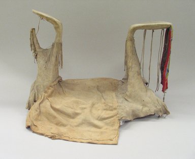 Blackfoot. <em>Lady's Fringed and Beaded High Pommeled Saddle</em>, first half 20th century. Hide, wood, wool, beads, 20 1/4 x 14 9/16in. (51.5 x 37cm). Brooklyn Museum, Bequest of W.S. Morton Mead, 32.2099.32563. Creative Commons-BY (Photo: Brooklyn Museum, CUR.32.2099.32563_view1.jpg)
